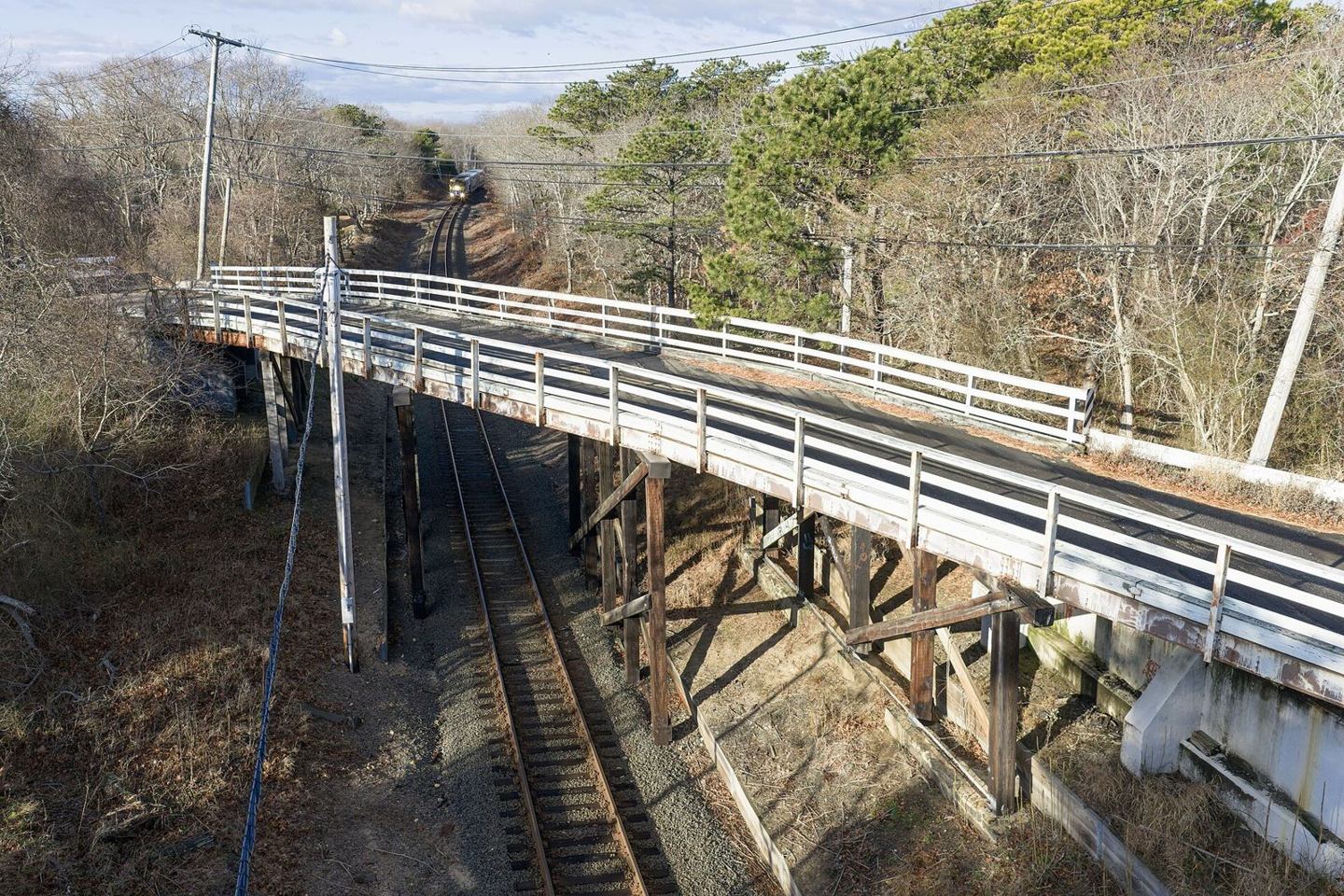 Cranberry Hole Road bridge between wooded banks in Amagansett