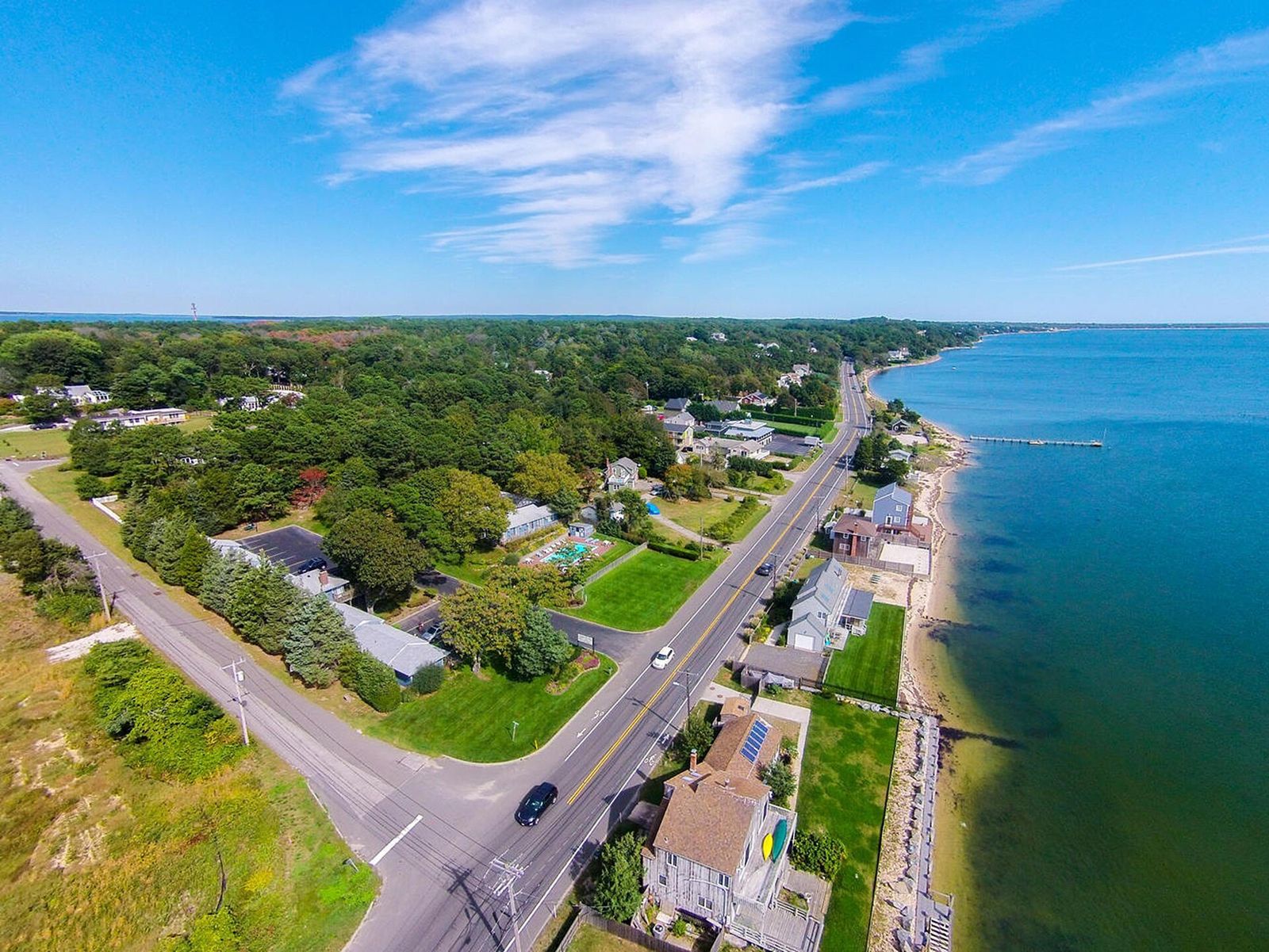 Aerial view of waterfront properties and trees in Hampton Bays
